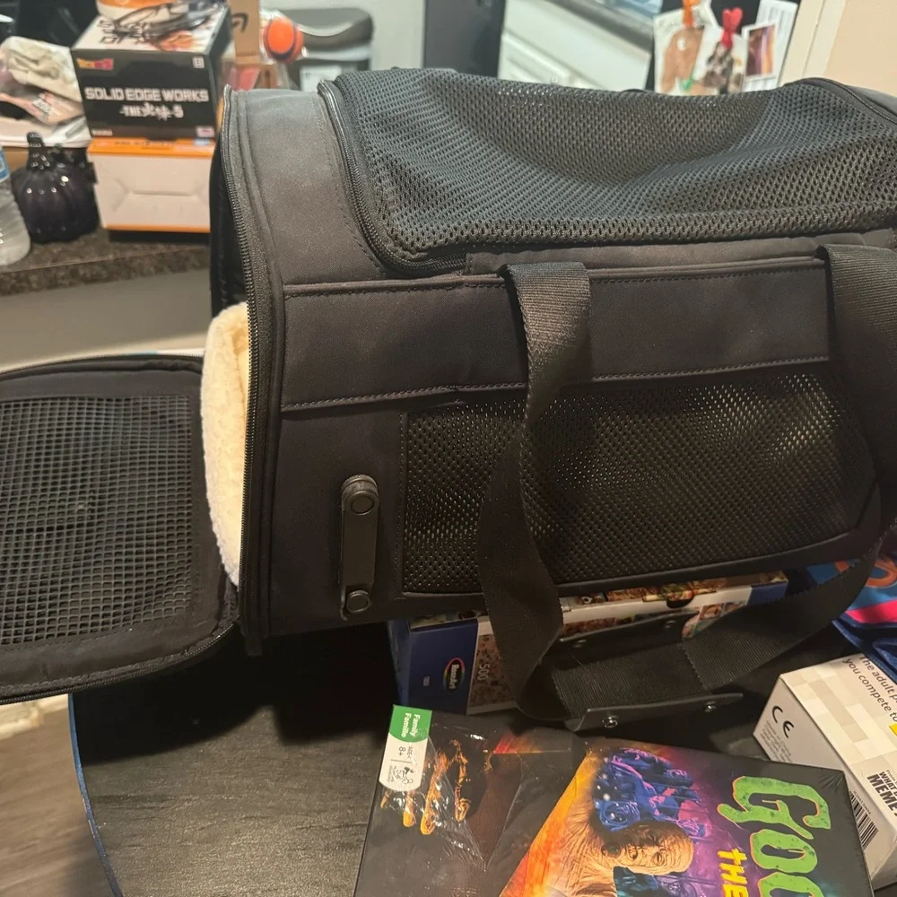 Small dog carrier. a little bed inside. Never used. Two openings. 2 sidezippers